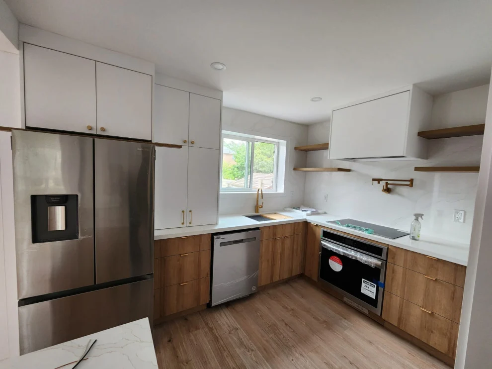 U-shaped kitchen with white uppers, warm wood lower cabinets, open shelves and stainless appliances