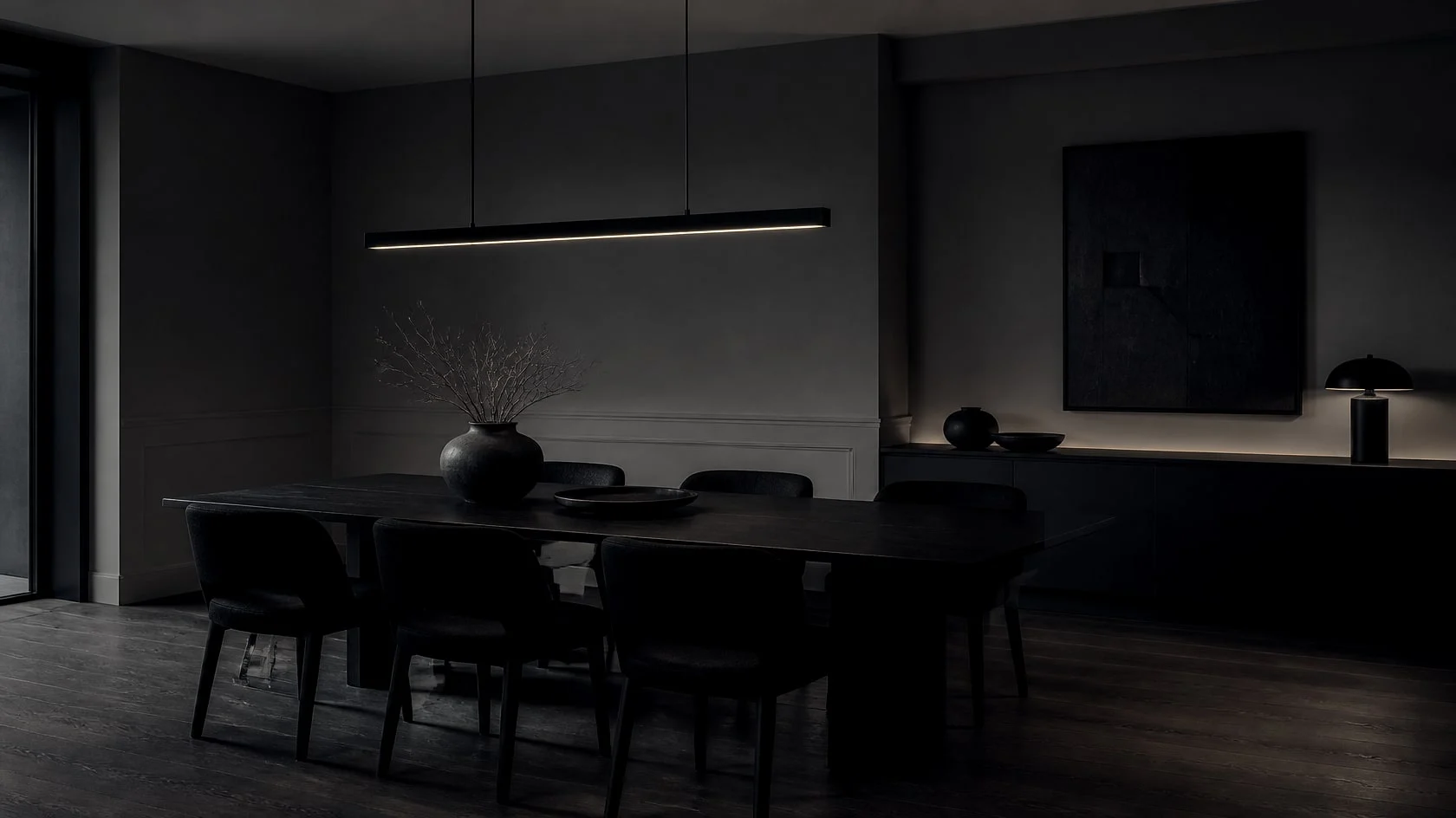 Dark dining room with a long table, a linear pendant and warm greige painted walls